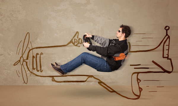 Funny pilot driving a hand drawn airplane on the wall