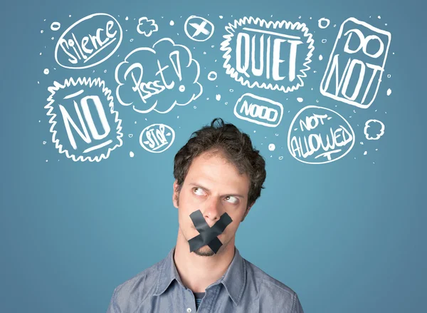 Young man with glued mouth and thought clouds — Stock Photo, Image