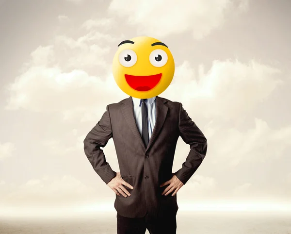 Businessman wears yellow smiley face — Stock Photo, Image