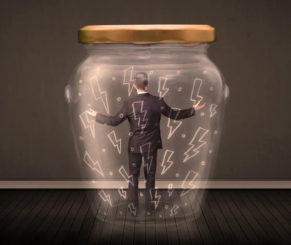 Businessman inside a glass jar with lightning drawings concept — Stock Photo, Image