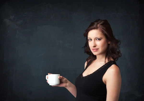 Businesswoman holding a white cup — Stock Photo, Image