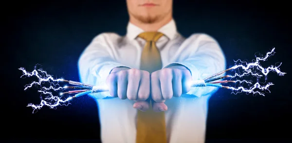 Business person holding electrical powered wires — Stock Photo, Image