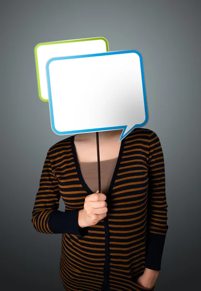 Young woman holding speech bubble — Stock Photo, Image