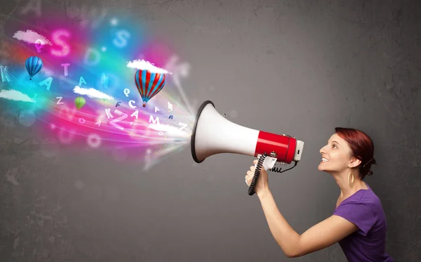 Girl shouting into megaphone and abstract text and balloons come — Stock Photo, Image