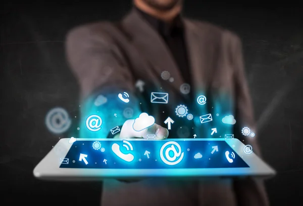 Person holding a tablet with blue technology icons and symbols — Stock Photo, Image