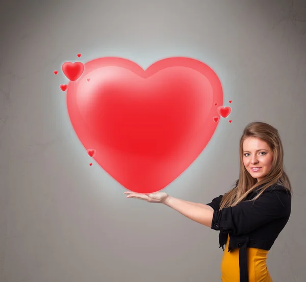 Fiatal hölgy kezében szép 3d piros szív — Stock Fotó