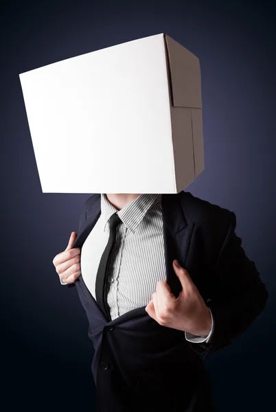 Businessman gesturing with a cardboard box on his head — Stock Photo, Image