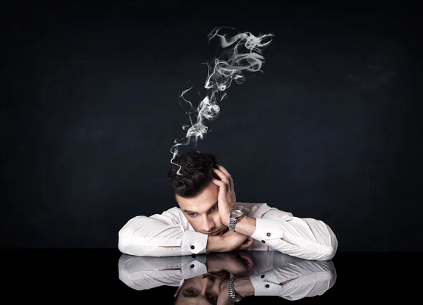 Depressed businessman with smoking head — Stock Photo, Image