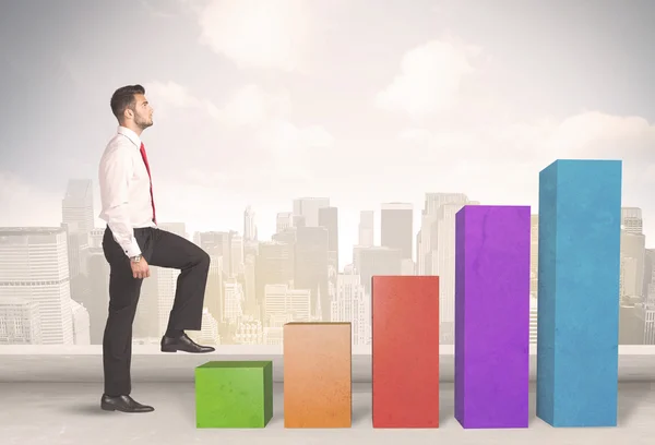 Business person climbing up on colourful chart pillars concept — Stock Photo, Image