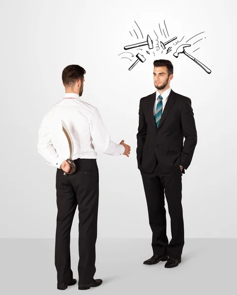 Businessman hiding a weapon — Stock Photo, Image