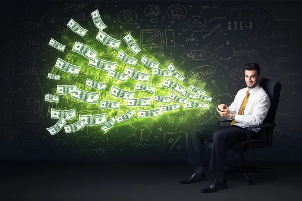 Businessman sitting in chair holding tablet with dollar bills co — Stock Photo, Image