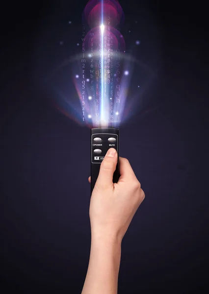 Hand with remote control and shining numbers — Stock Photo, Image