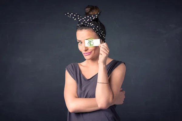 Young girl holding paper with green dollar sign — Stock Photo, Image