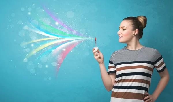 Mooi meisje blazen abstracte kleurrijke bubbels en lijnen — Stockfoto