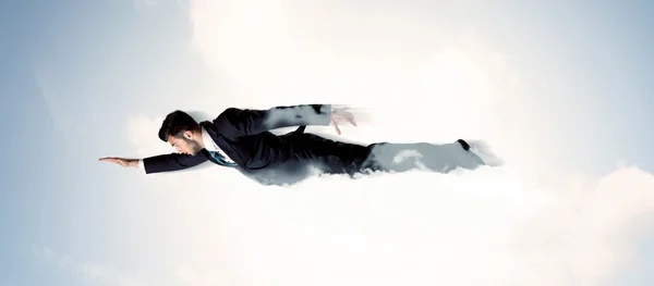 Business man flying like a superhero in clouds on the sky — Stock Photo, Image