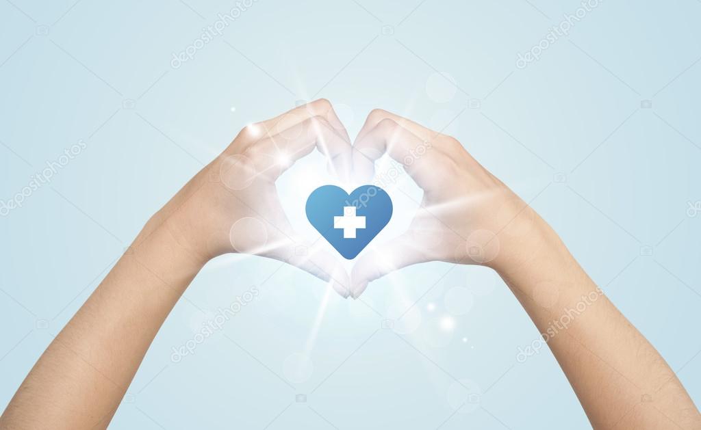 Hands creating a form with heart blue cross