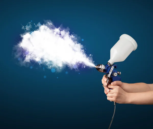 Painter with airbrush gun and white magical smoke — Stock Photo, Image