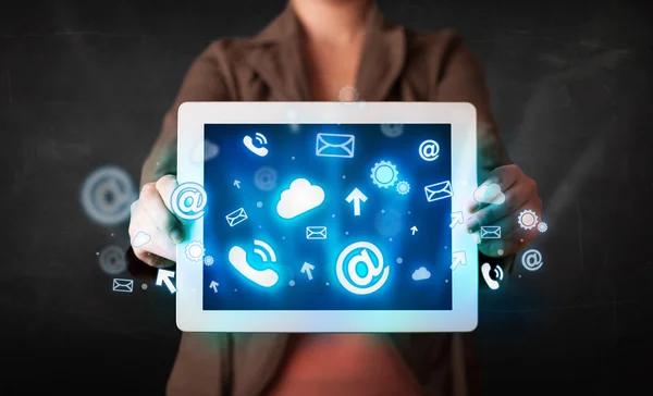 Person holding a tablet with blue technology icons and symbols — Stock Photo, Image