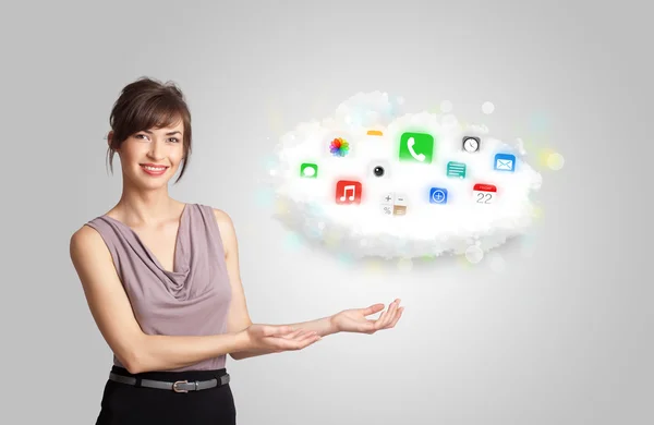 Young woman presenting cloud with colorful app icons and symbols — Stock Photo, Image