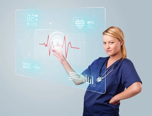 Young nurse pressing modern medical type of buttons — Stock Photo, Image