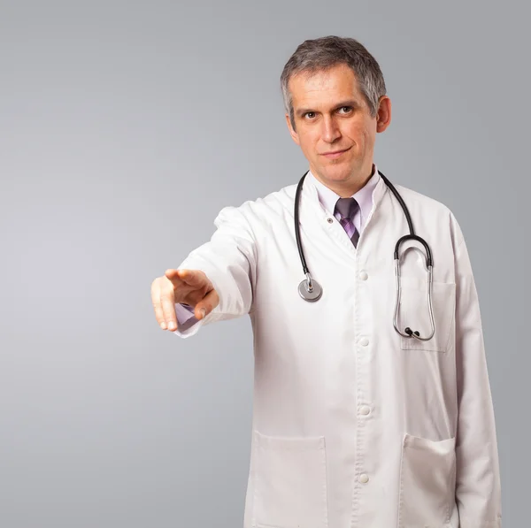 Middle aged doctor gesturing with copy space — Stock Photo, Image