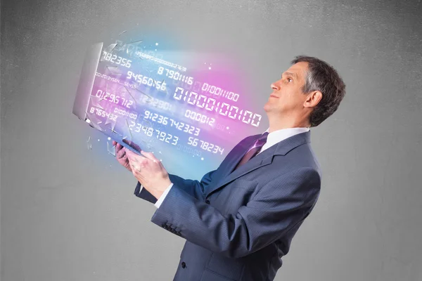 Üzletember kezében notebook robbanó adatok és számok — Stock Fotó