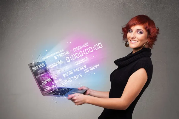 Casual woman holding laptop with exploding data and numers — Stock Photo, Image