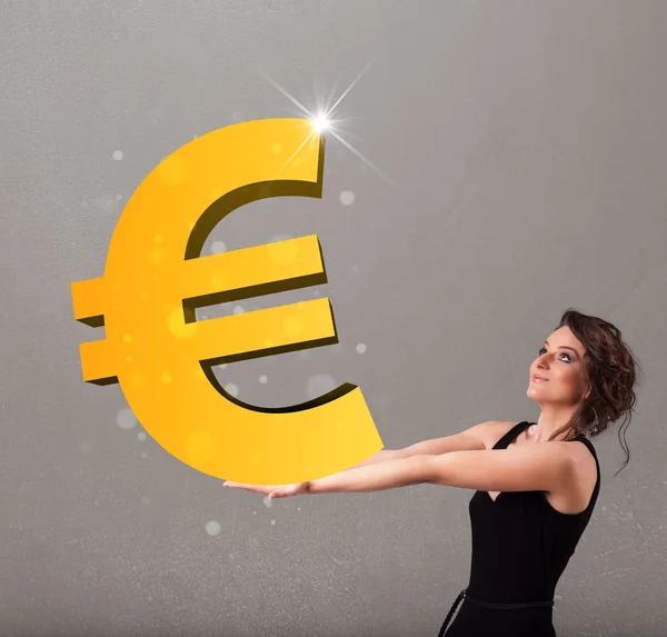 Menina bonita segurando um grande 3d sinal de ouro euro — Fotografia de Stock