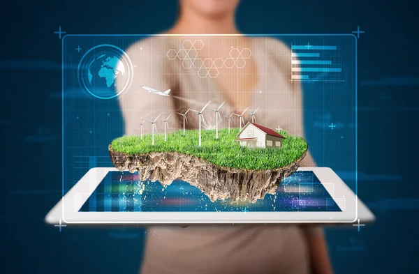 Woman presenting a perfect ecology land with a house and windmil — Stock Photo, Image
