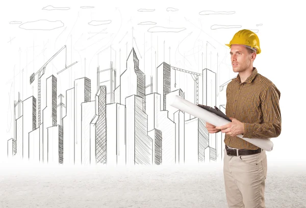 Engineer man with building city drawing in background — Stock Photo, Image