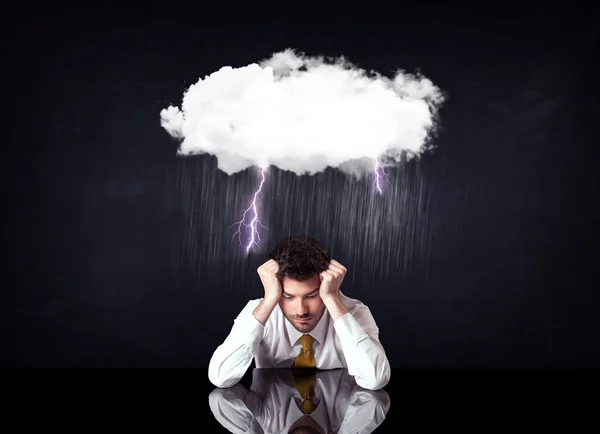 Depressed businessman sitting under a cloud — Stock Photo, Image