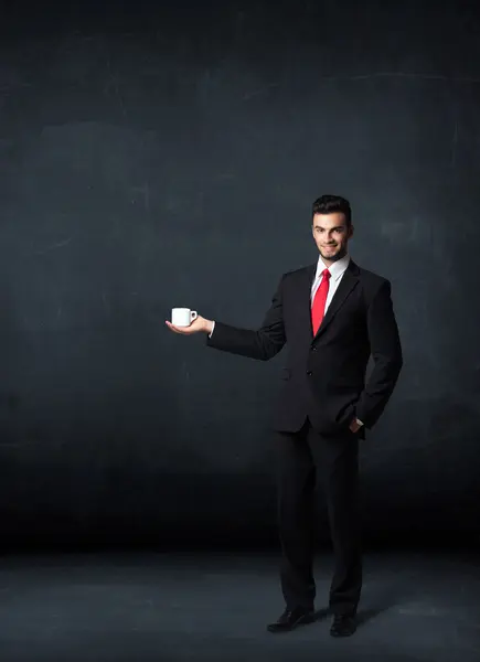 Businessman holding a white cup — Stock Photo, Image