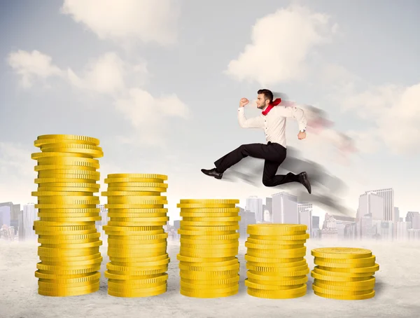 Successful business man jumping up on gold coin money — Stock Photo, Image