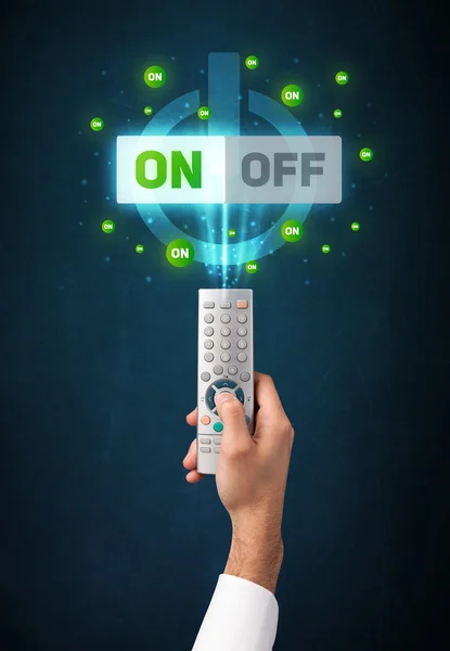 Mano con telecomando e segnali on-off — Foto Stock