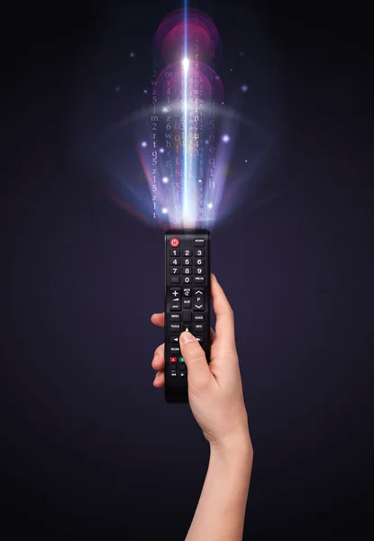 Hand with remote control and shining numbers — Stock Photo, Image