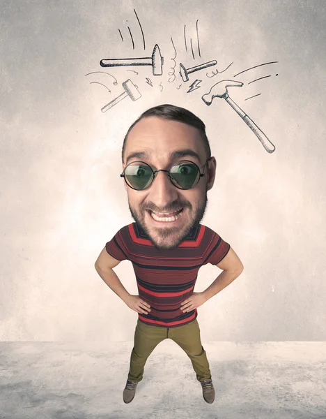 Big head person with drawn hammers — Stock Photo, Image