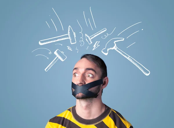 Young man with glued mouth and beating hammer marks — Stock Photo, Image