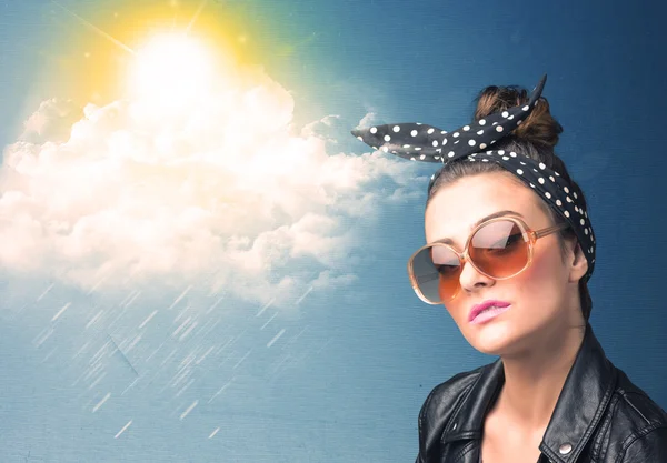 Young person looking with sunglasses at clouds and sun — Stock Photo, Image