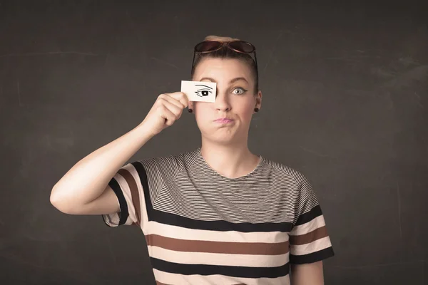 Silly youngster looking with hand drawn eye paper — Stock Photo, Image