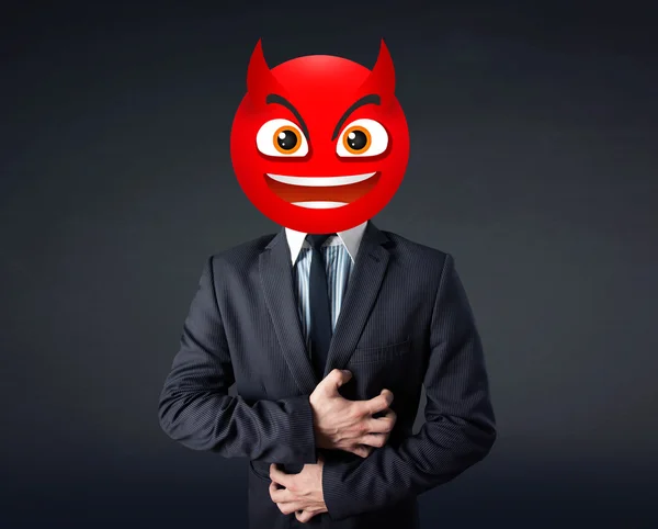 Obchodník nosí ďábelský smajlík — Stock fotografie