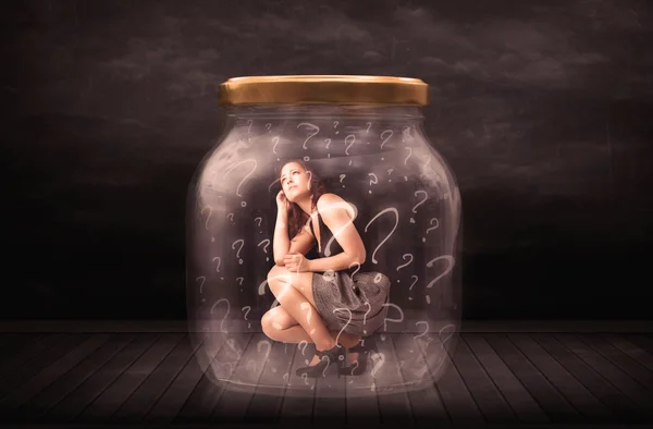 Businesswoman locked into a jar with question marks concept — Stock Photo, Image