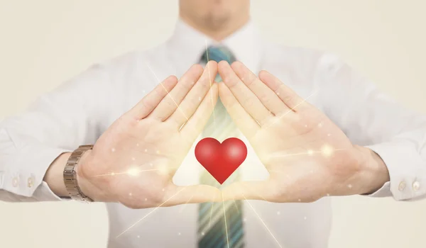 Hands creating a form with shining heart — Stock Photo, Image