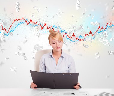 Borsa grafiğiyle masada oturan iş kadını. 
