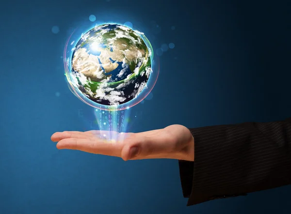 Businessman holding a glowing earth globe — Stock Photo, Image