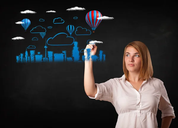 Pretty woman sketching cityscape with colorful balloons — Stock Photo, Image