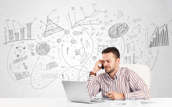 Business man at desk with hand drawn charts — Stock Photo, Image