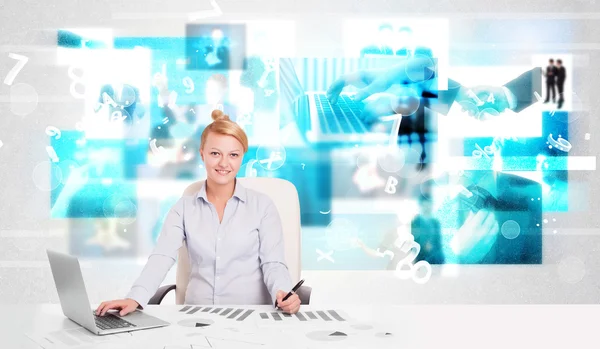 Business person at desk with modern tech images at background — Stock Photo, Image