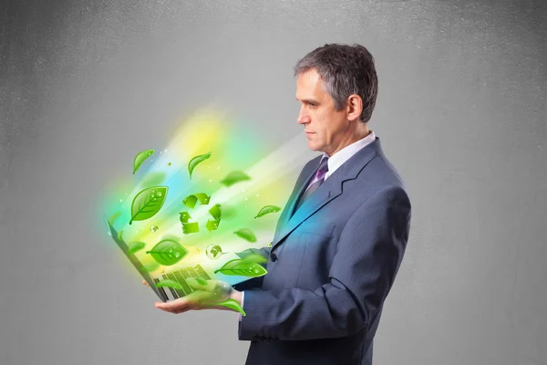 Businessman holding laptop with recycle and environmental symbo — Stock Photo, Image