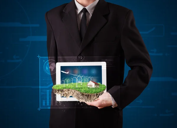 Businessman presenting a perfect ecology land with a house and w — Stock Photo, Image