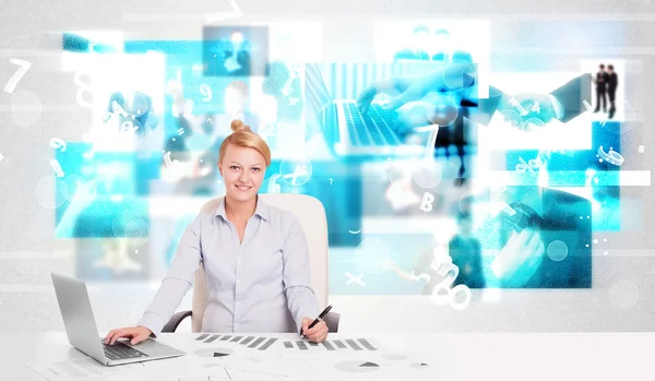 Business person at desk with modern tech images at background Royalty Free Stock Photos